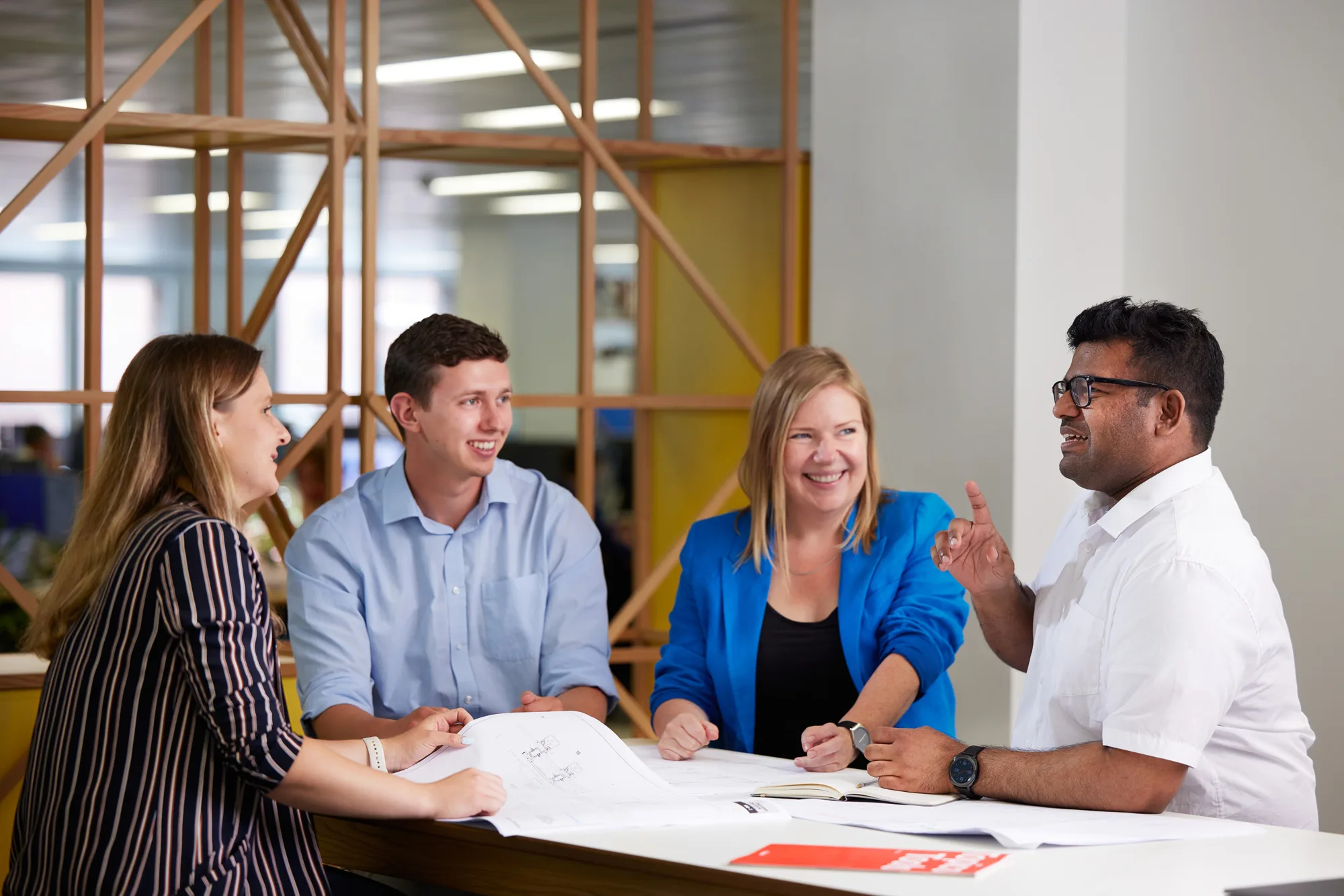 Cundall employees around desk discussing work
