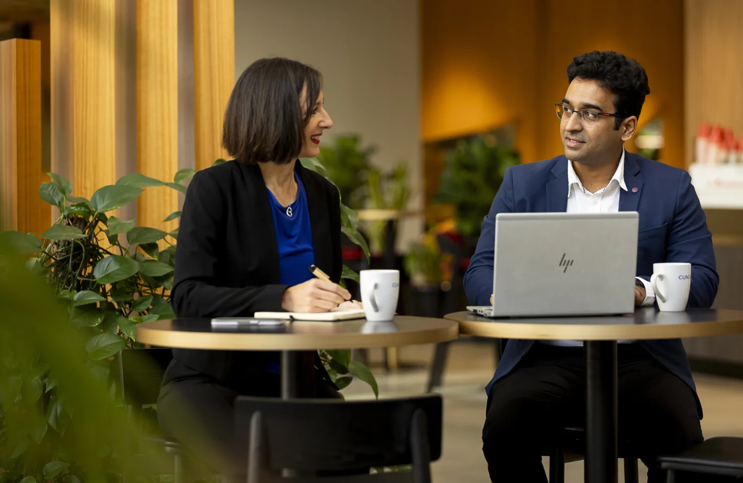 Cundall employees sitting together discussing a project with laptops
