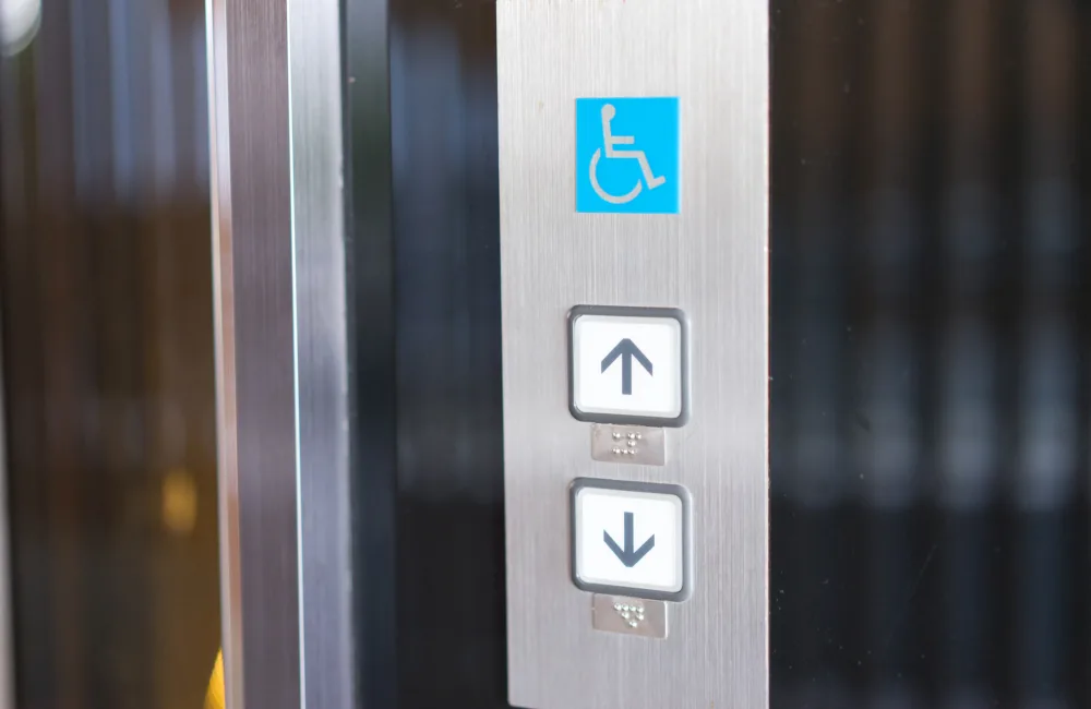 Disabled sign above 2 lift buttons on a interior lift panel