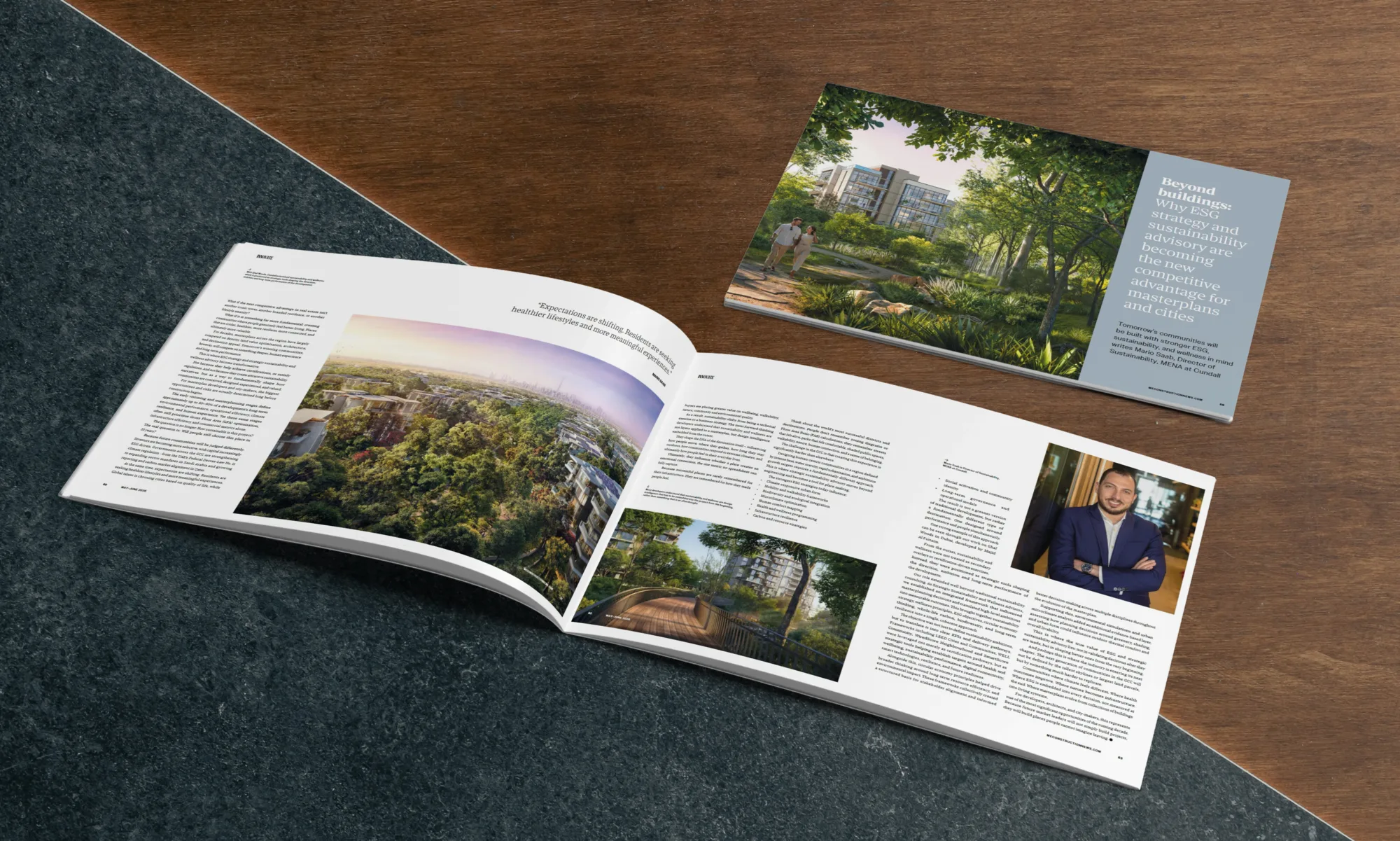 An open magazine lies on a stone and wood surface, displaying articles with images of a landscaped residential area and a walkway; visible text includes a headline page reading “Beyond buildings: Why ESG strategy and sustainability advisory are becoming the new competitive advantage for masterplans and cities.”