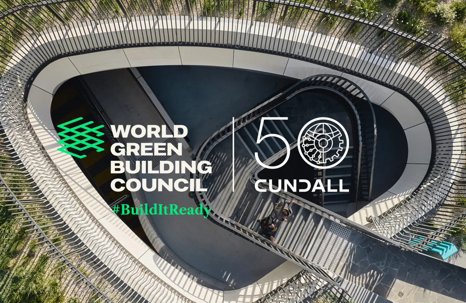 Aerial view of a curved stairway and landscaped walkway with World Green Building Council and Cundall 50 anniversary branding overlay.