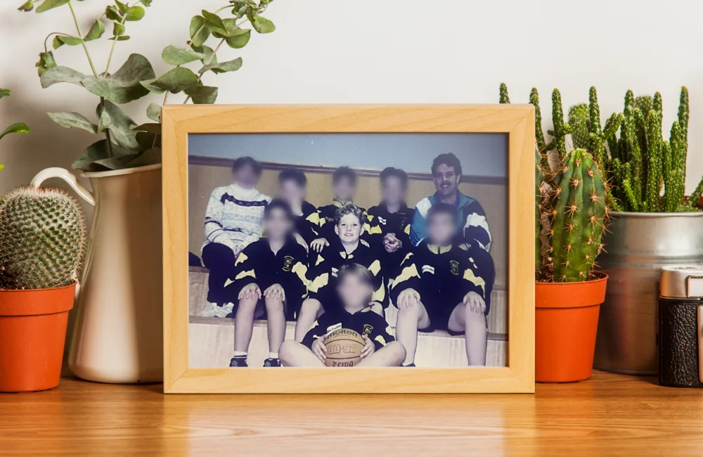 A very old photograph of David Collins with the basketball team together with his dad as their coach.