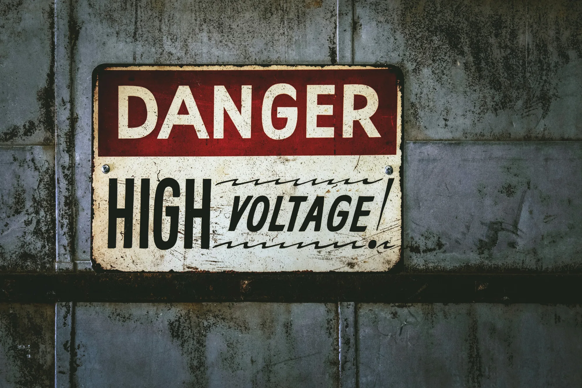 Danger High voltage metal sign on grey metal wall