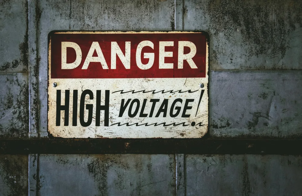Danger High voltage metal sign on grey metal wall