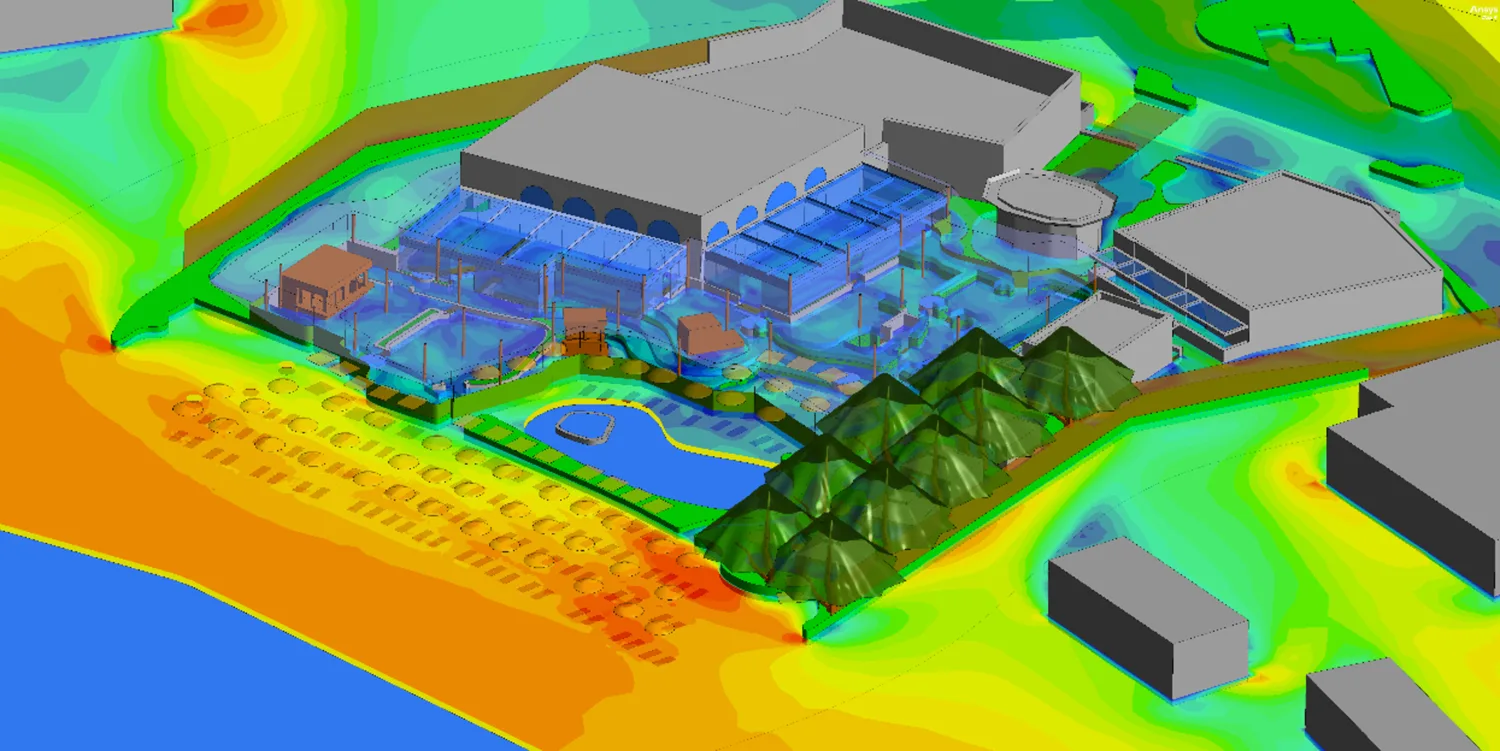 Computational fluid dynamics visualisation of airflow around a building complex, showing velocity contours and wind patterns across landscaped outdoor areas.