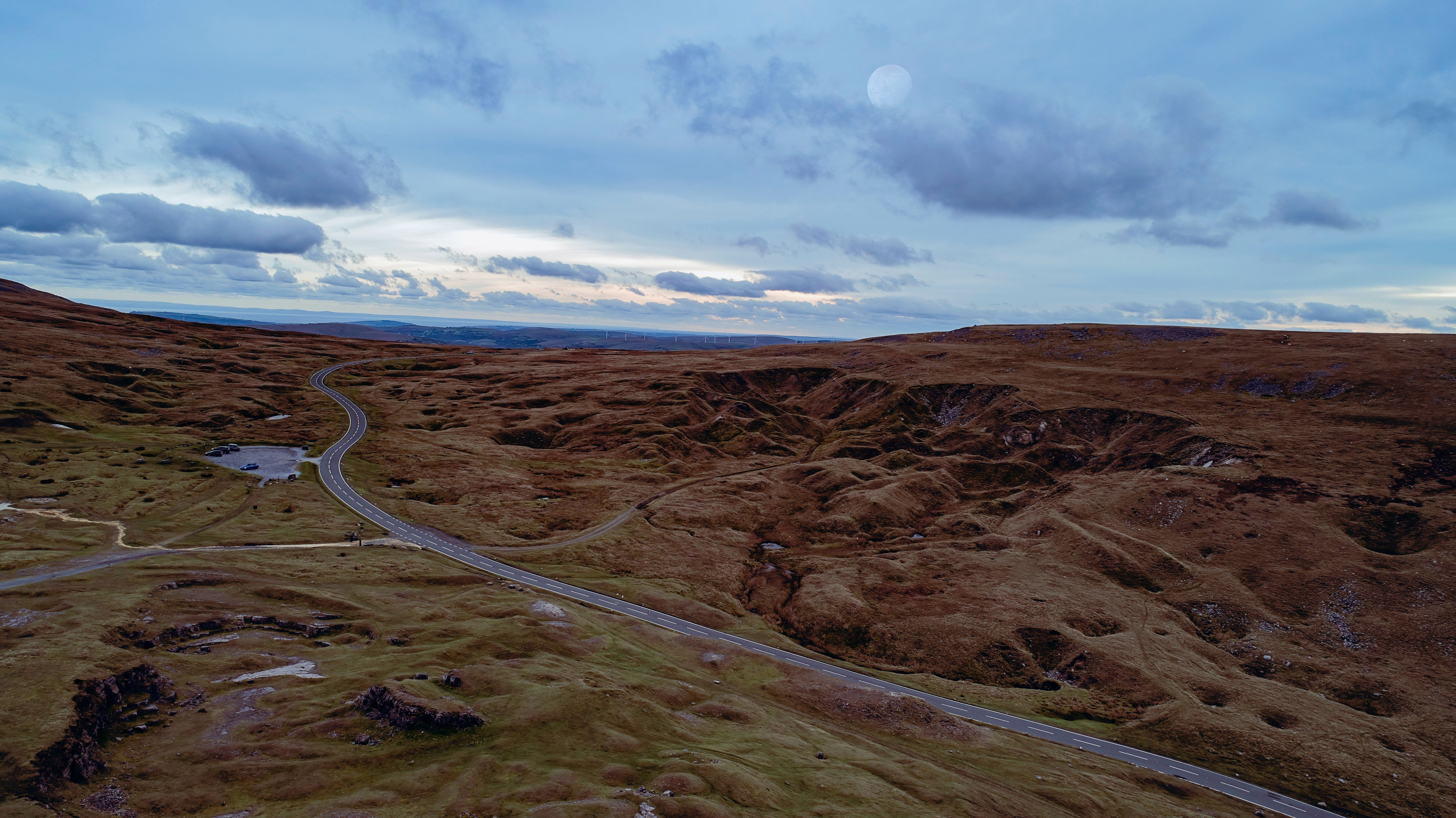 view of road through brecon beacons showing cloudy sky