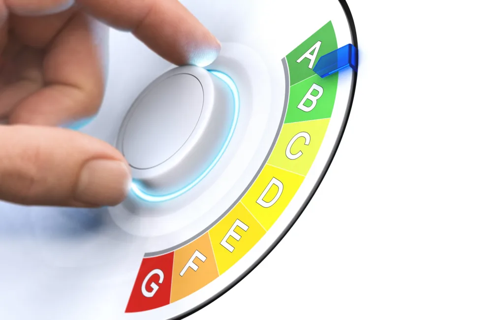 Hand turning a dial around energy efficiency rating labels