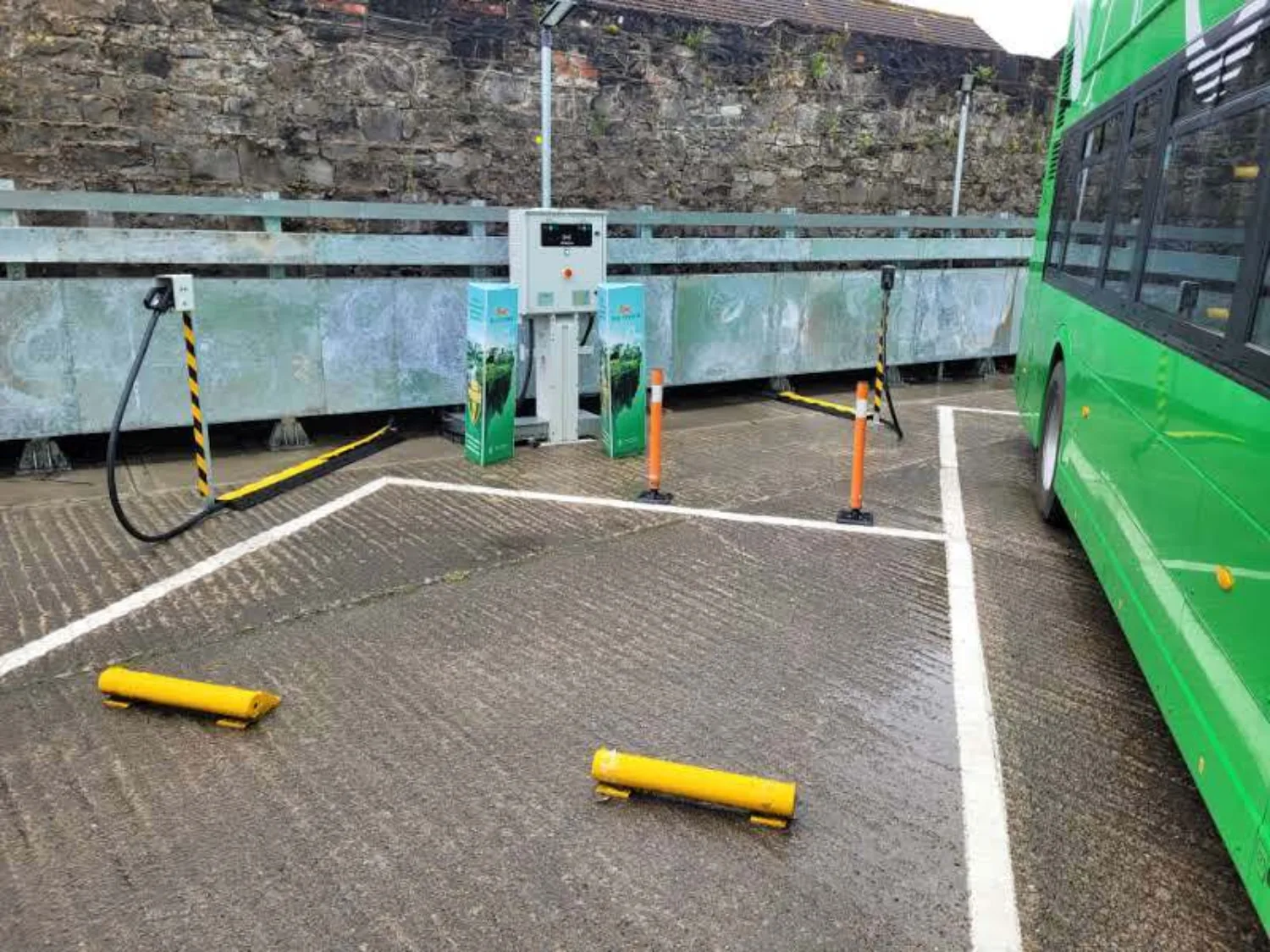 Electric bus behind a pedestal charger in Summerhill depot