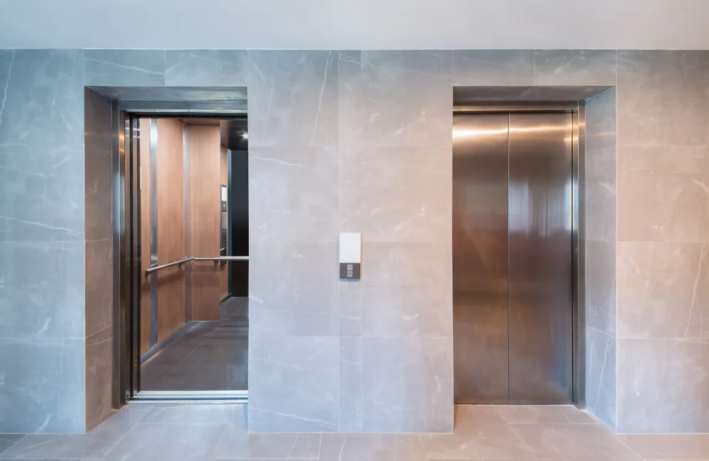 Two lifts in a lobby, one with open doors