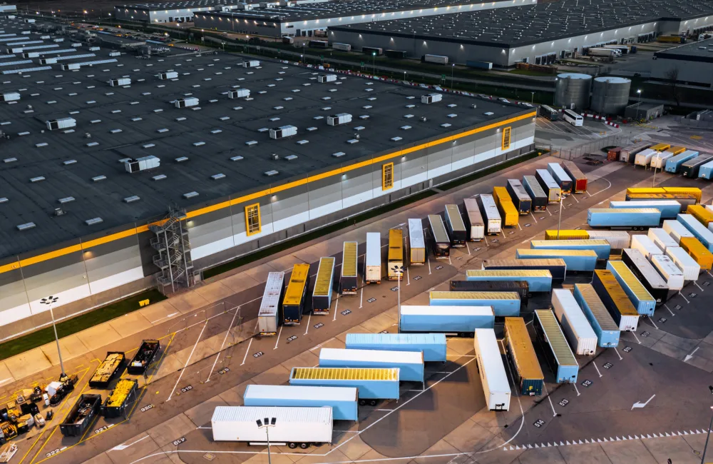 An aerial view of a large logistics center during twilight