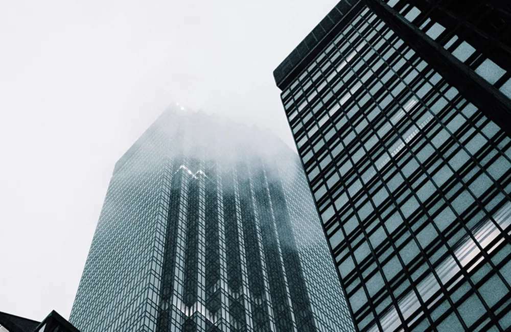 Skyscapers set against a grey cloudy sky