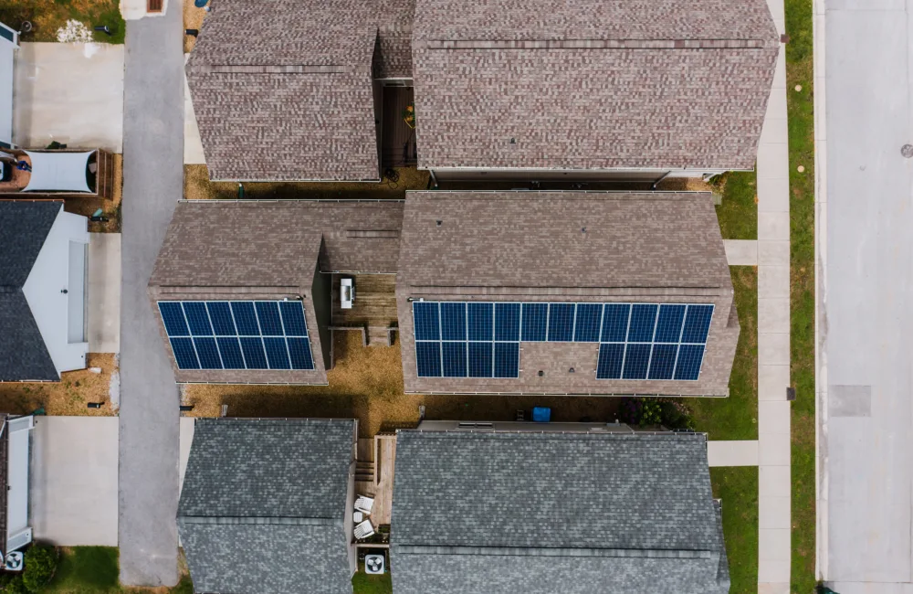 Aerial view of solar panels on a house roof in a residential neighbourhood