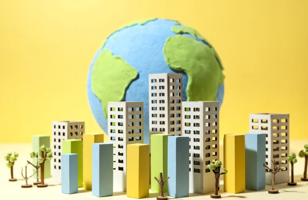 3D model of a globe, surrounded by buildings and trees.