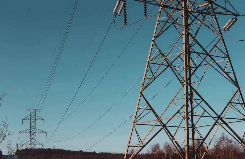 Electric power lines against a blue sky