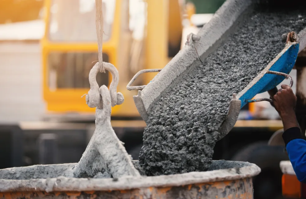 concrete pouring machine pouring into a bucket