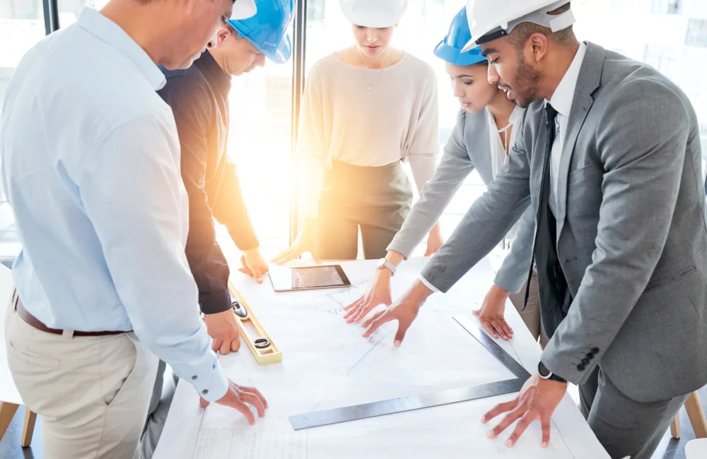 A group of engineers composed of men and women having a discussion about a project at work