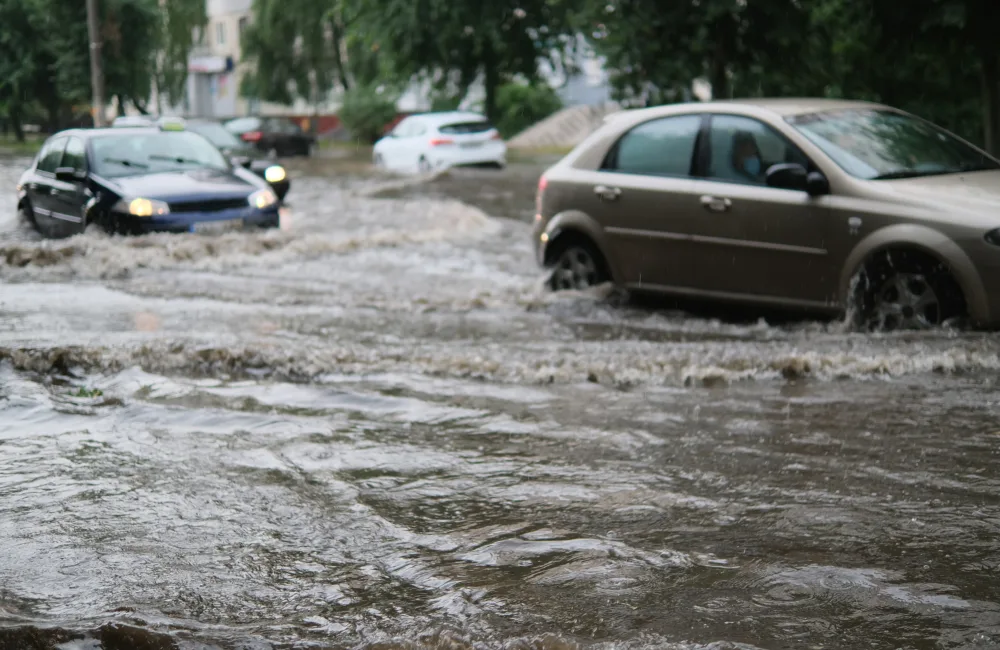 Cars driving through flooded street