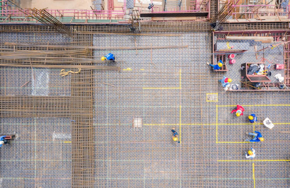 Arial shot of a construction site showing workers and building foundations