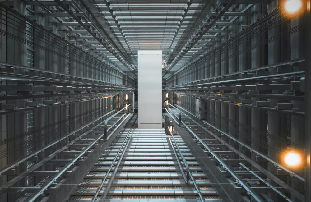 Looking up through a steel lift shaft