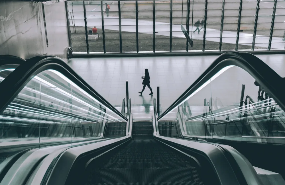 Looking down from the top of an escalator down to a large reception
