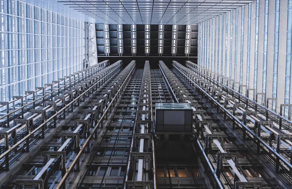 View of a wide multi-lift elevator shaft from below