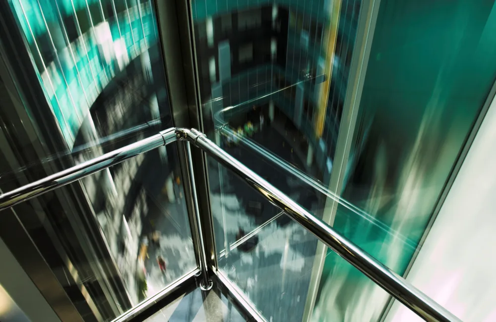 The inside of a glass-walled moving elevator