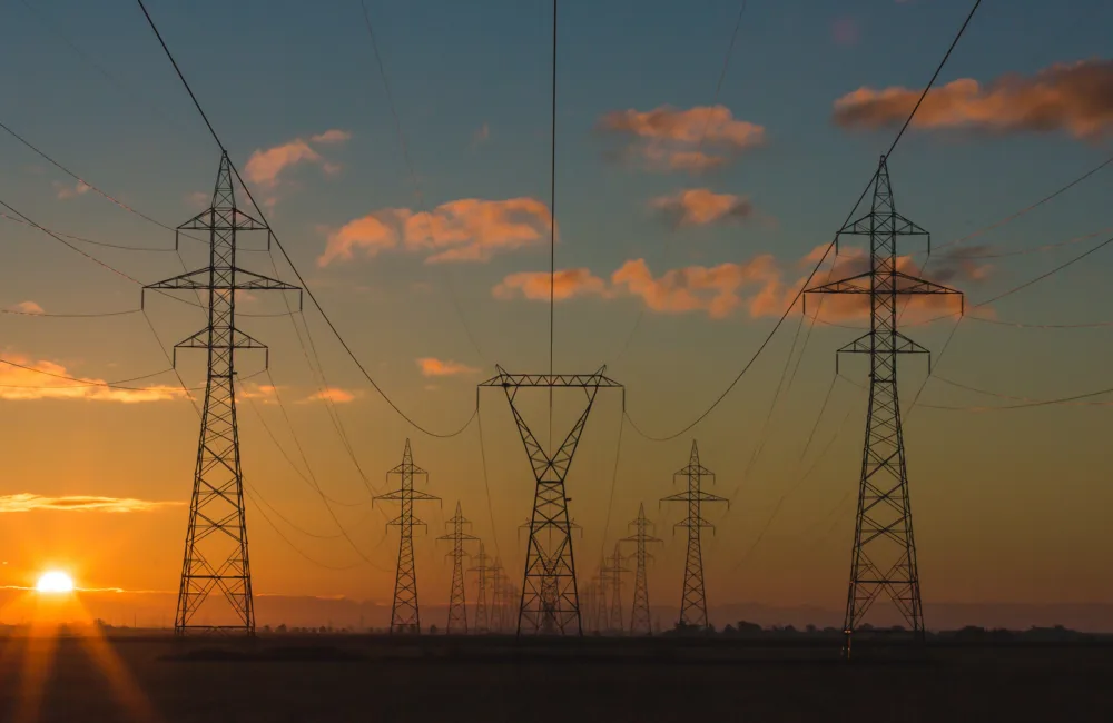 A series of pylons against a sunset