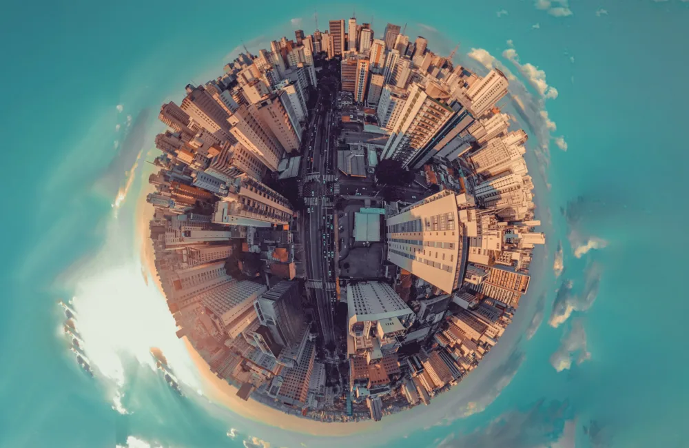Stylised overhead view of a city to look like a globe surrounded by a blue sky