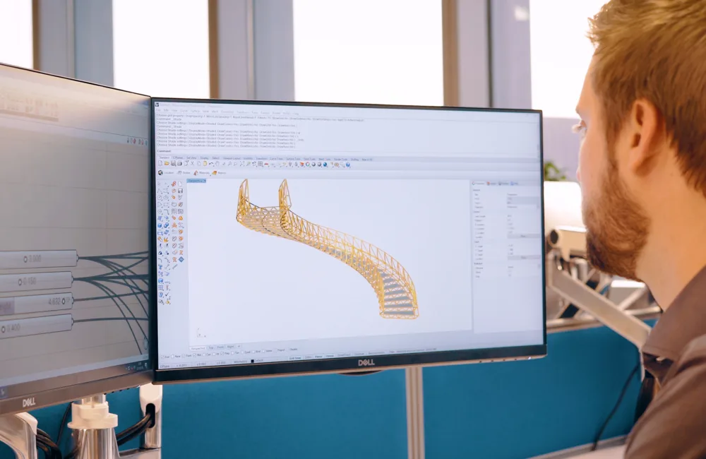 Calum sat at his desk looking at a parametric model on 2 screens