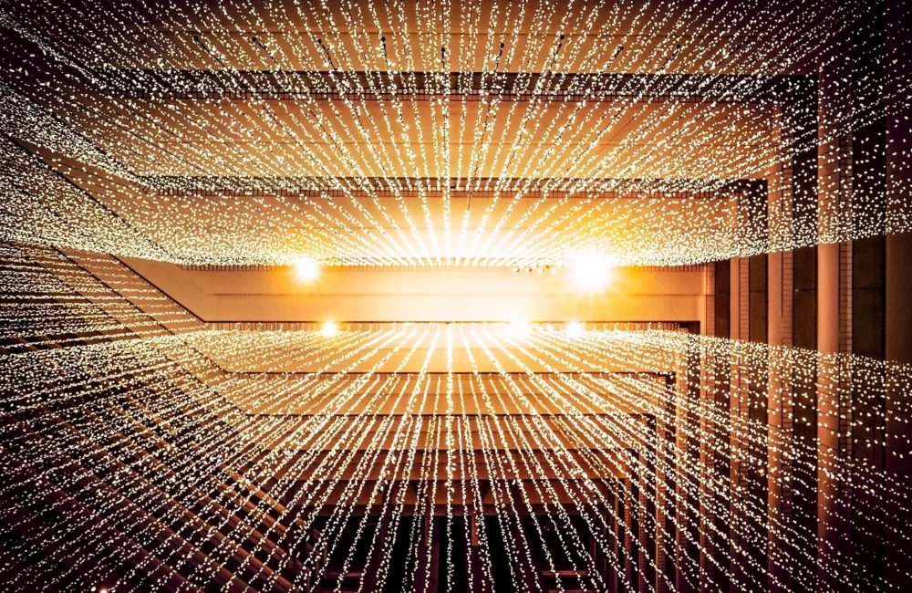 Hanging trails of lights mirrored on both sides of the building