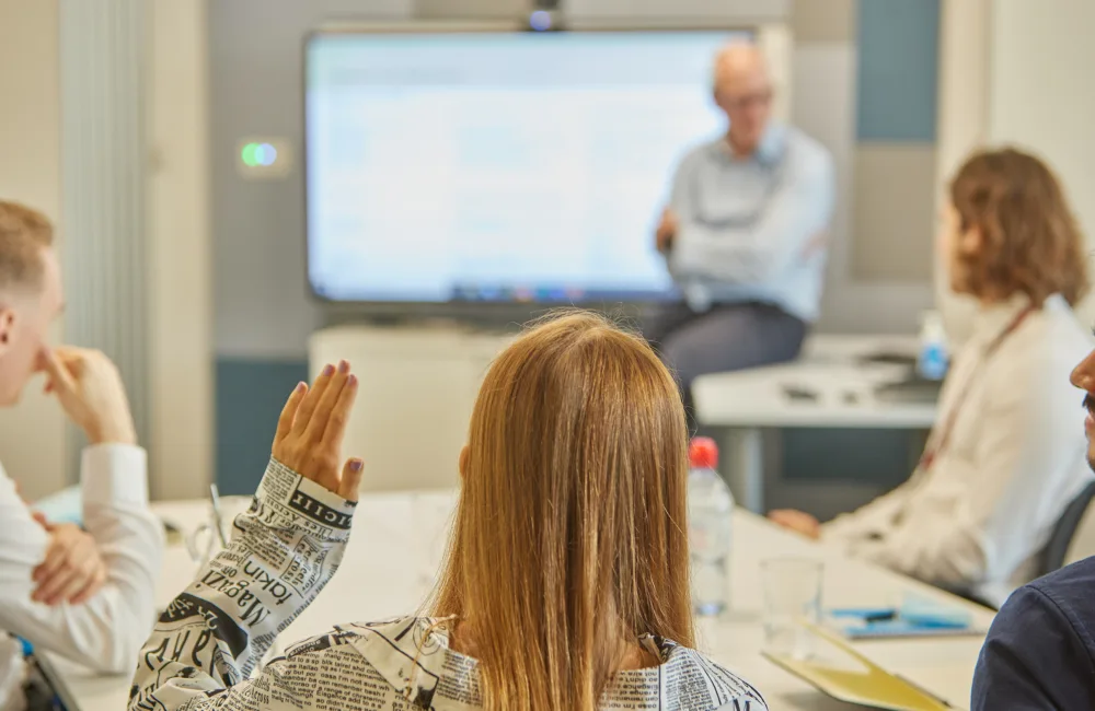 Girl raising hand during meeting