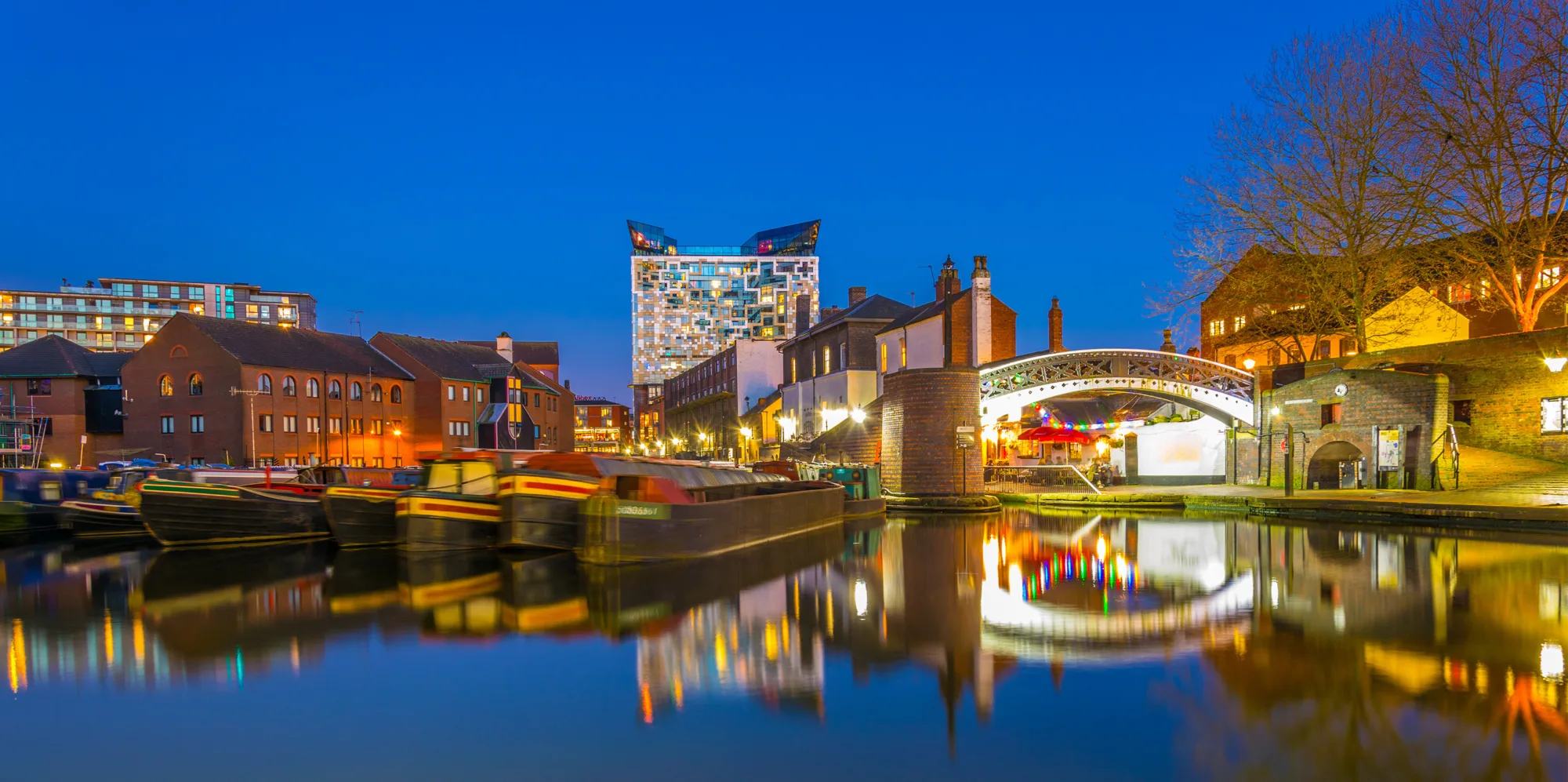 The cube behind brick buildings alongside a water channel in the central Birmingham, England