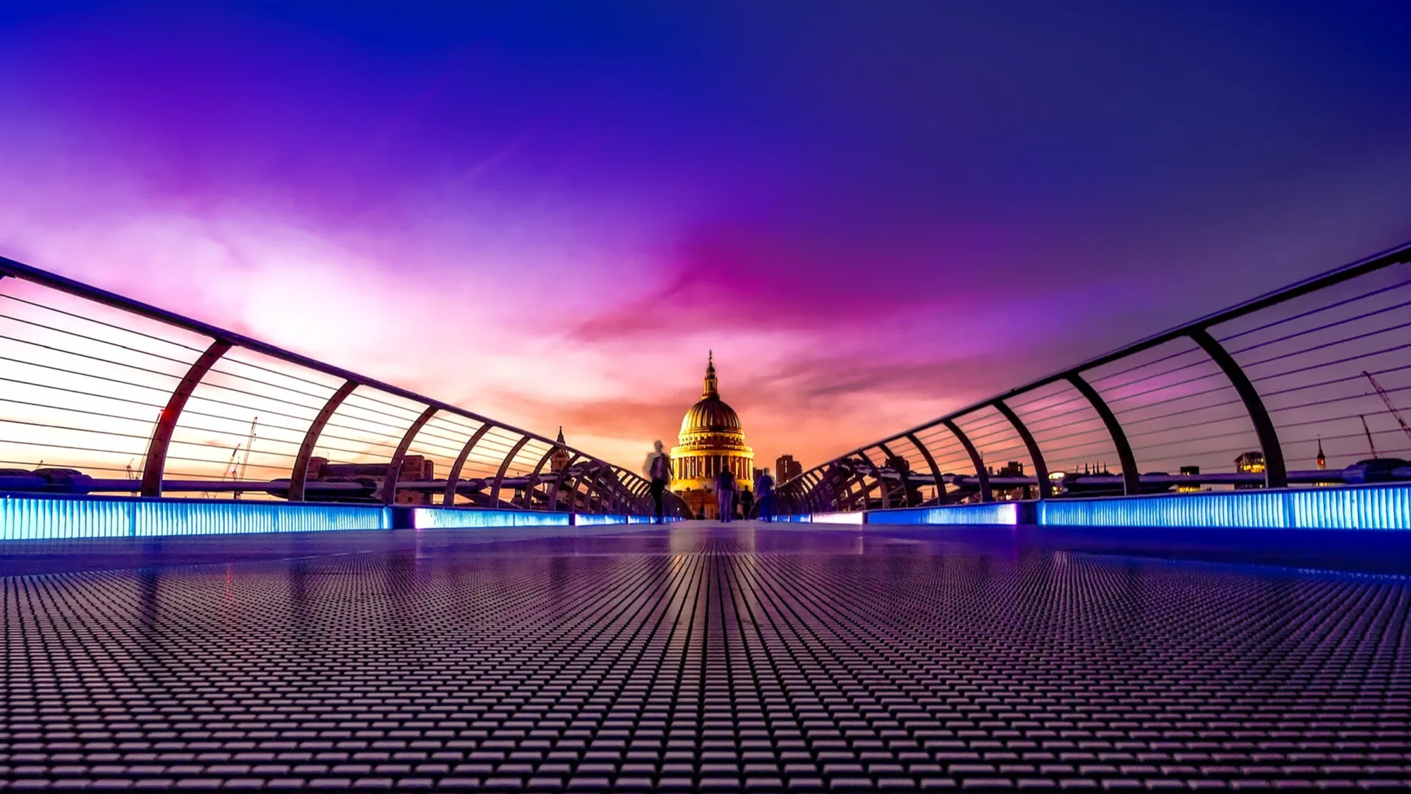 Purple sky over the Millennium Bridge with Saint Pauls Cathedral, London, in the distance