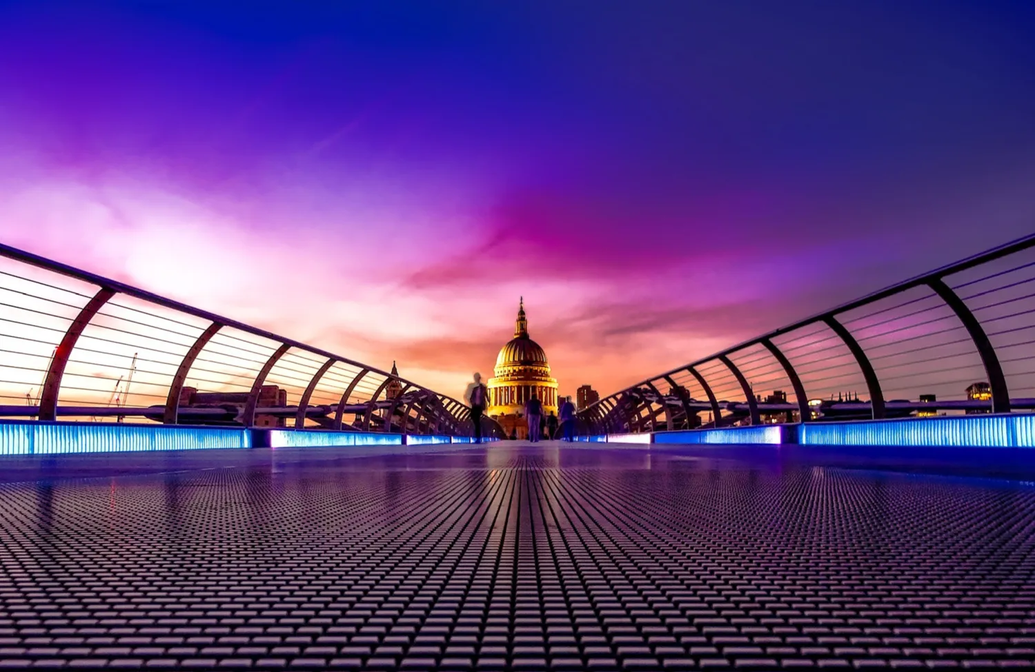 Purple sky over the Millennium Bridge with Saint Pauls Cathedral, London, in the distance