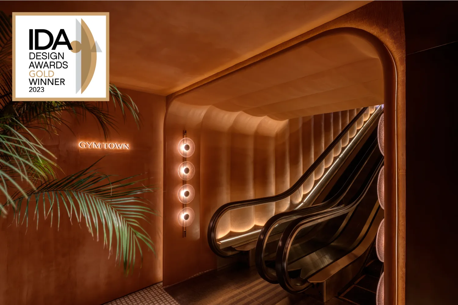 Entrance in GymTown with an escalator leading to the upper floor. Mood lighting also adds a great accent to the ambience.