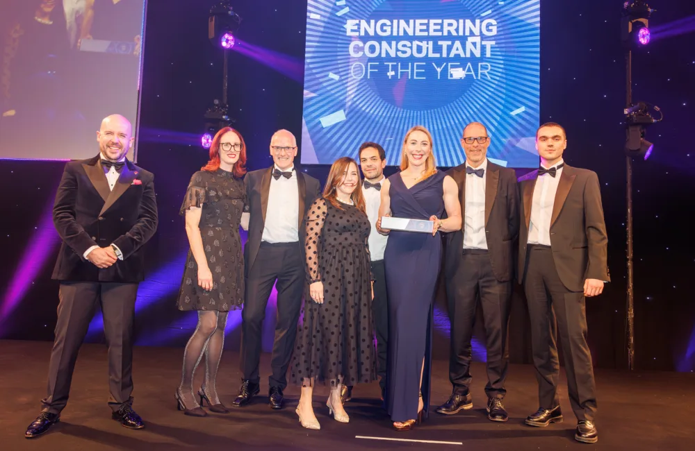 Cundall team on stage receiving the award in front of a large Engineering Consultant of the year screen