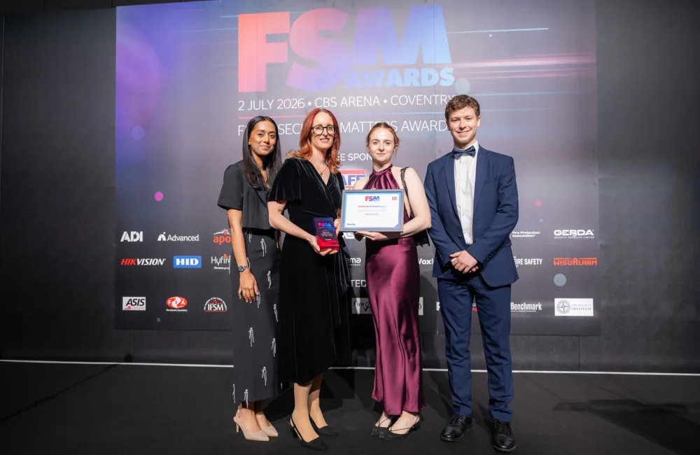 Four people stand on a stage holding a framed certificate and trophy in front of a backdrop reading “FSM Awards, 2 July 2026, CBS Arena, Coventry,” with sponsor logos displayed across the background.