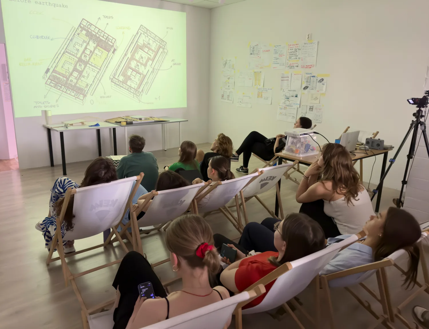 Students listening to the presentations while sitting comfortably on their seats.