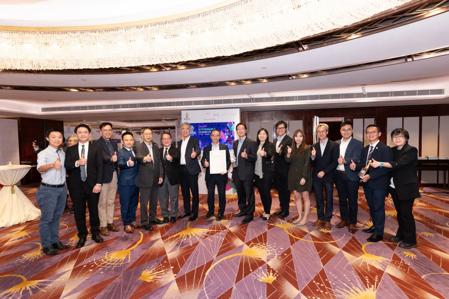 Award winning delegates standing on stage with certificate