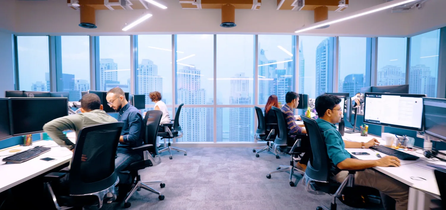 Cundall employees working on their desks in our Dubai office
