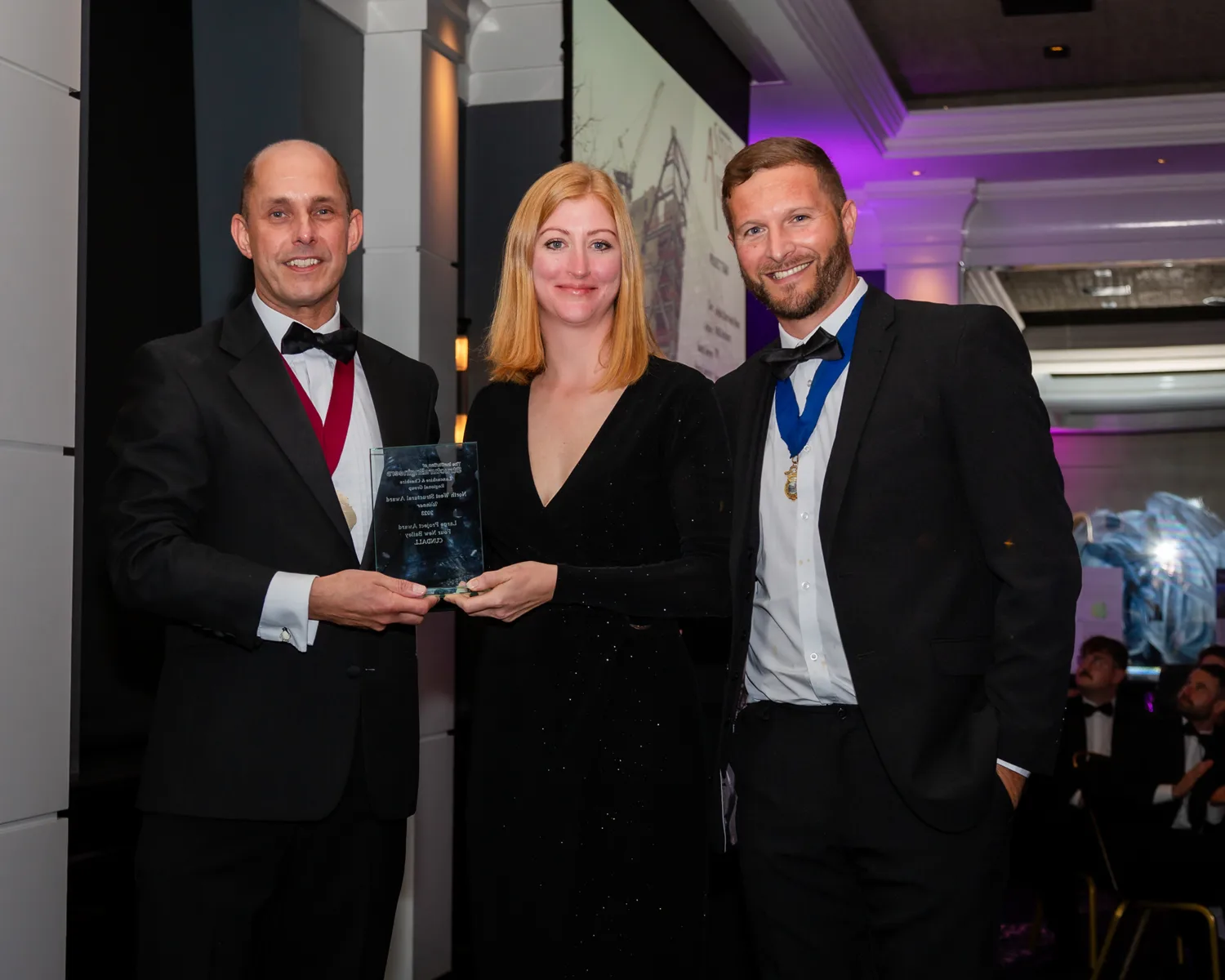 Clare Dawson on stage holding award for northwest strucutral award win