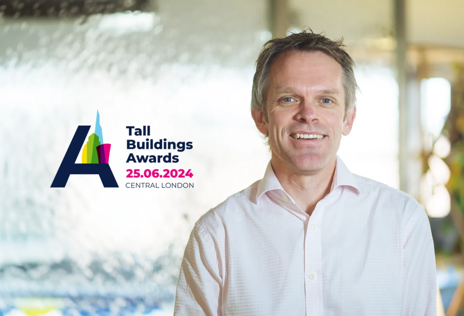 Headshot of Alex smiling with the Tall Building Awards logo on the left.