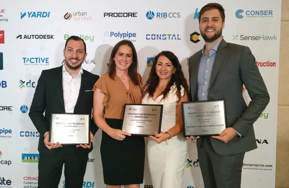 Our Cundall MENA colleagues posing for a photo while holding the 3 awards we won