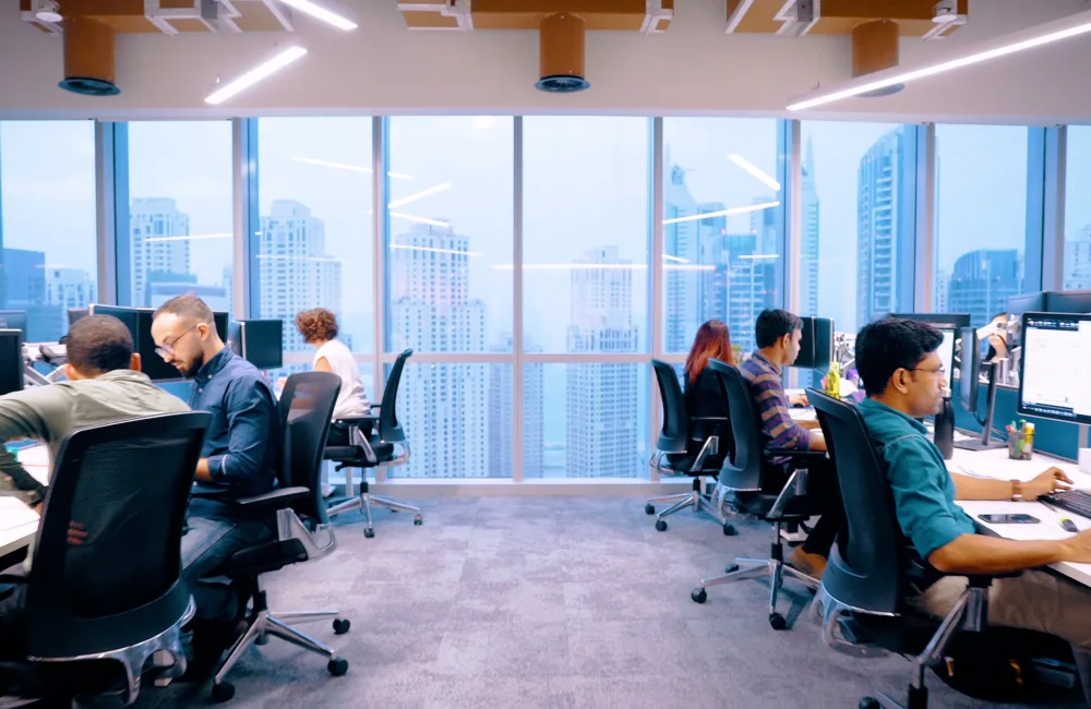 Cundall employees working on their desks in our Dubai office