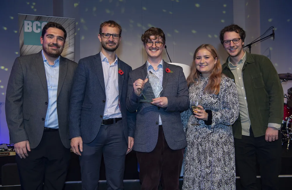 Timothy in the centre of the image holding his award next 4 colleagues