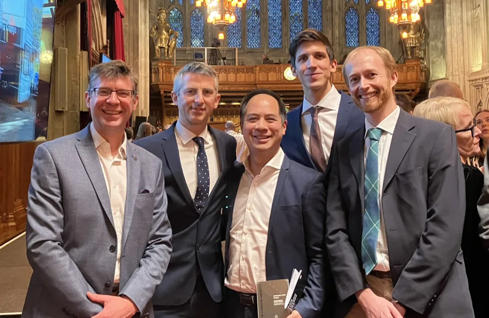 Group of employees smiling with an award.