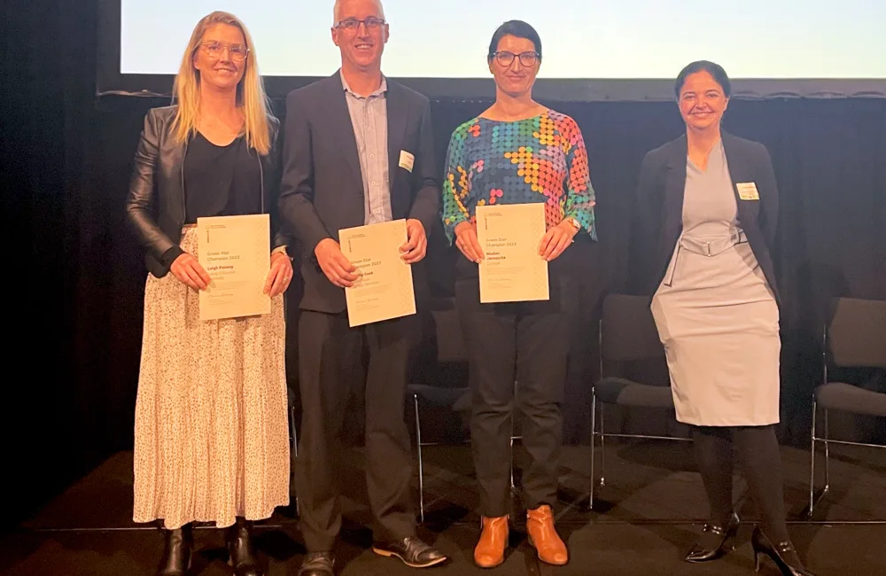 Madlen on stage with her certificate, 2 other winners and the presenter
