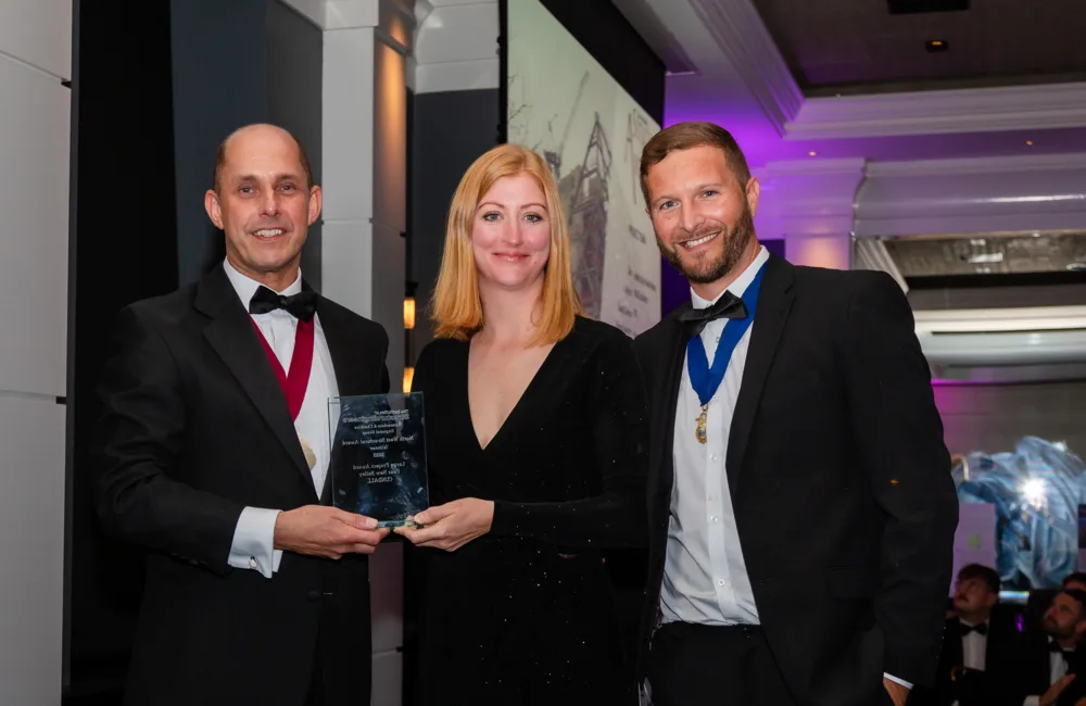 Clare Dawson on stage holding award for northwest strucutral award win