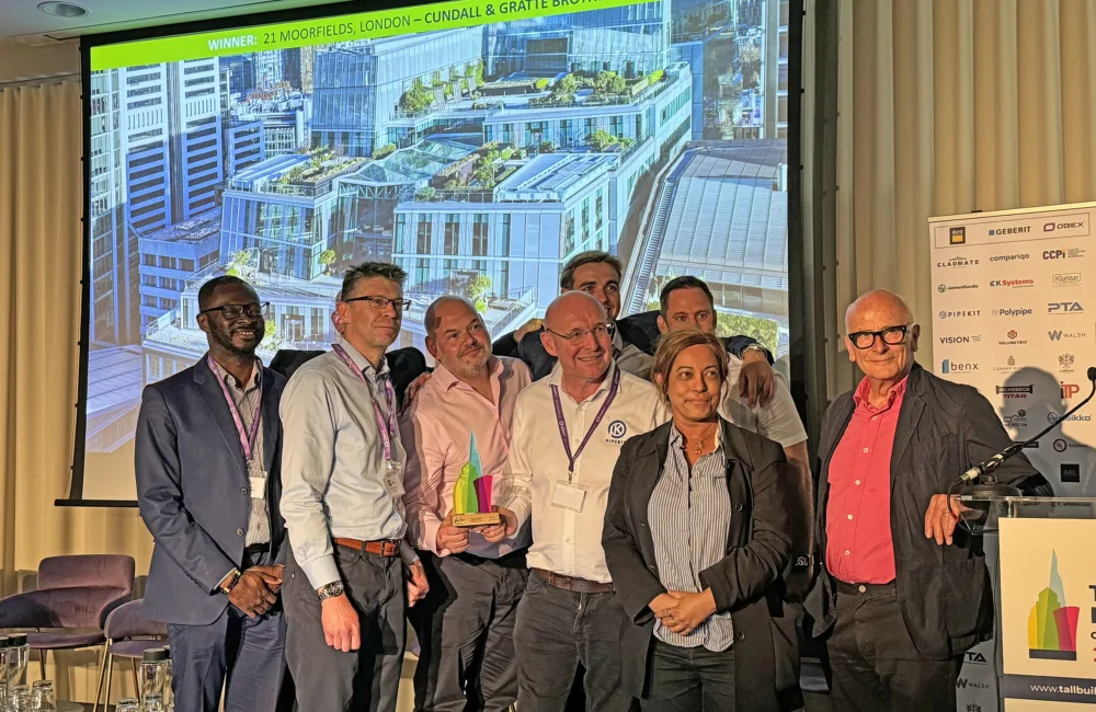 Project team on stage collecting award