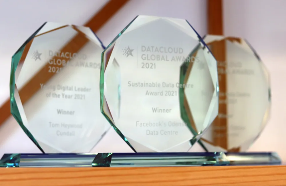 3 glass trophys sat on a wooden shelf